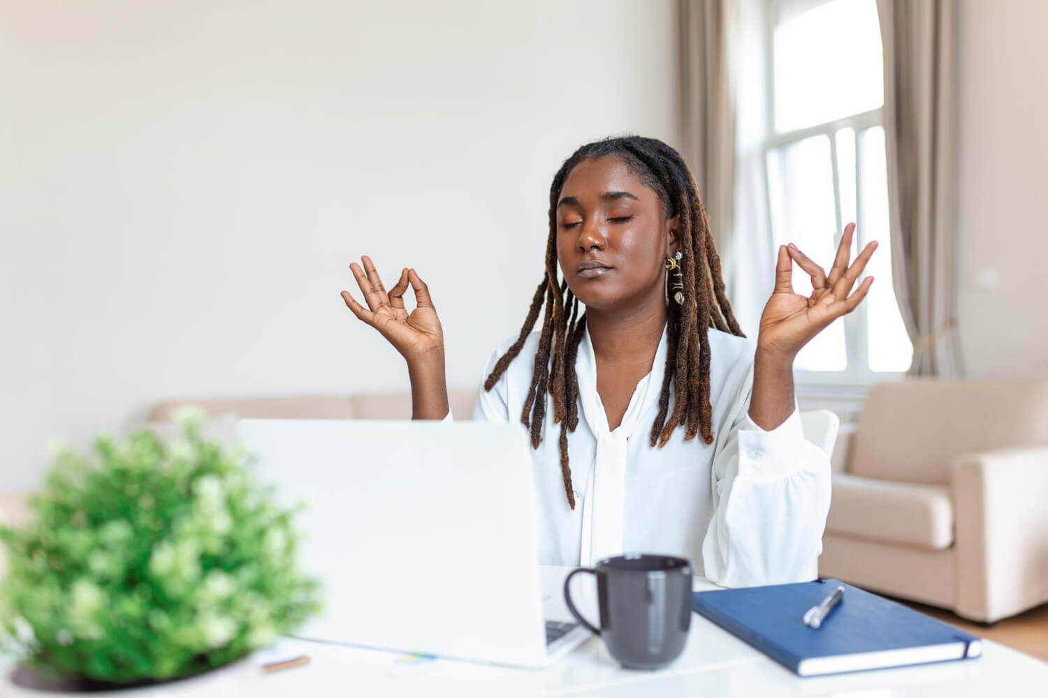 Calm mindful businesswoman feeling relief at work