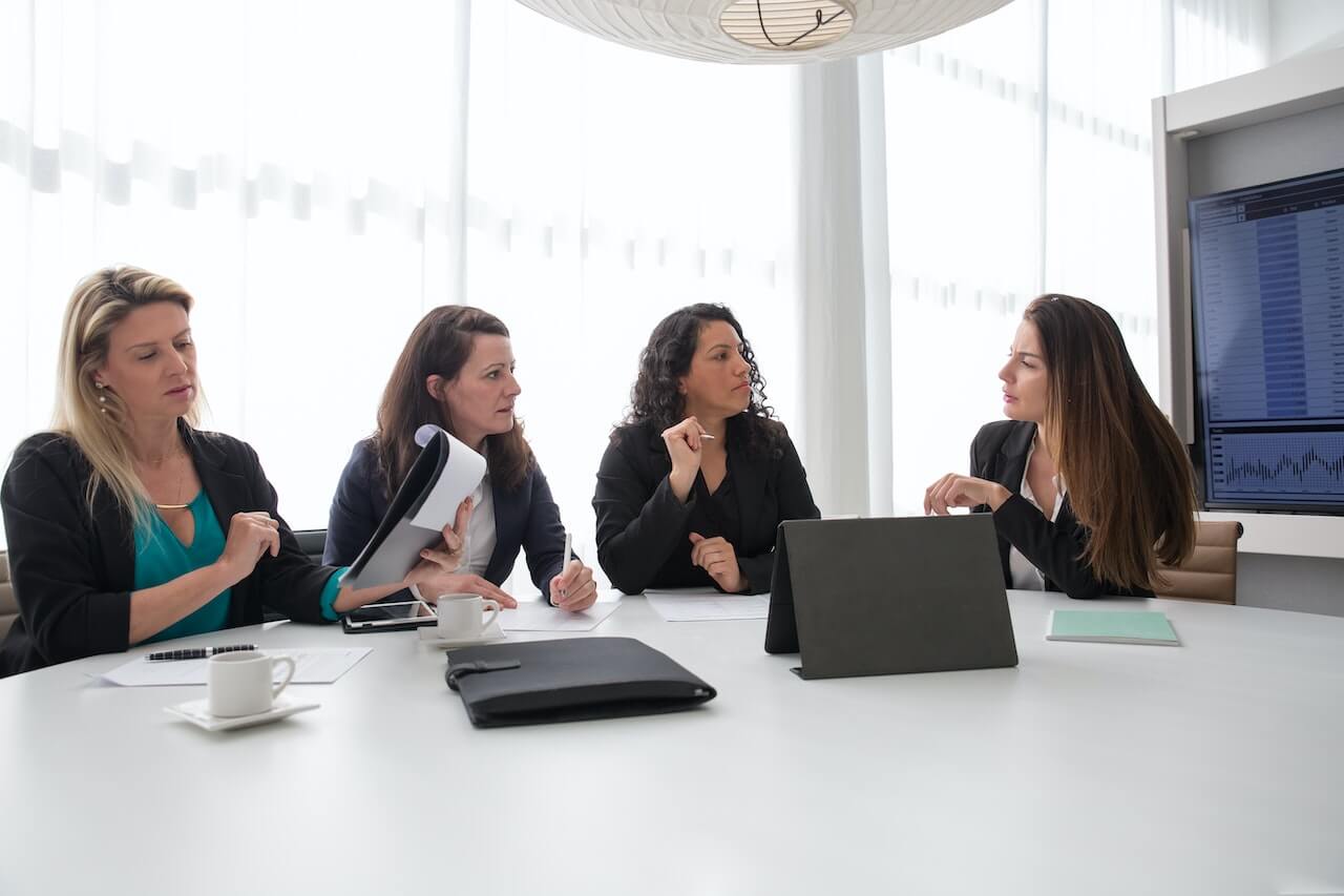 Group of Businesswomen Discussing Inside a Conference Room