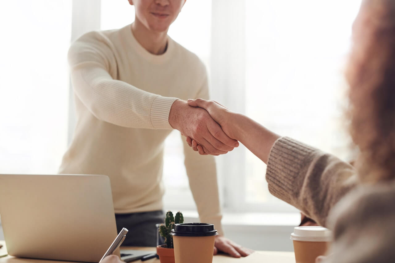 Man and woman shaking hands after a deal