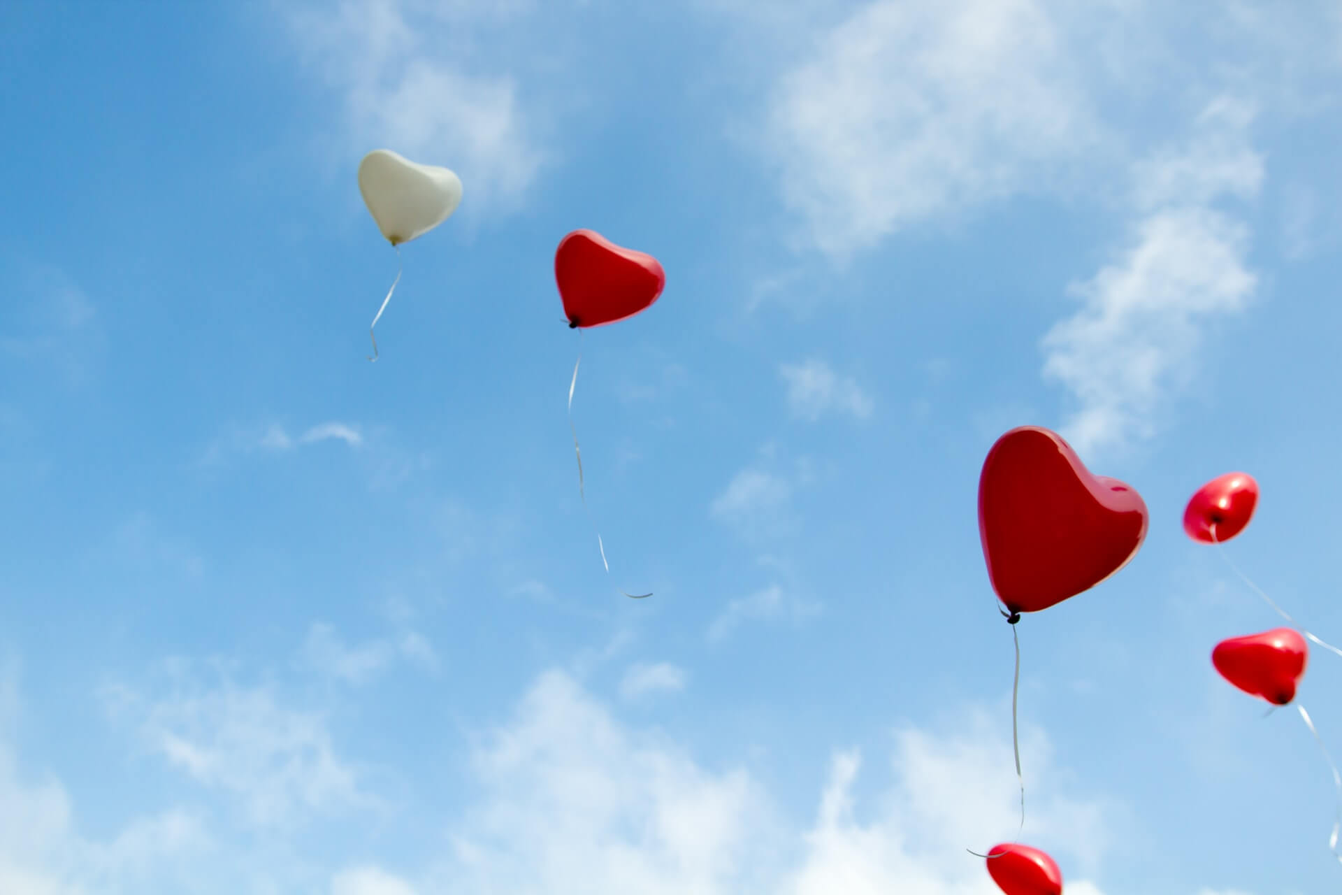 Red-and-white-love-shaped-balloons-floating-in-the-sky