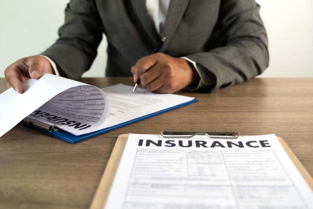 Businessman signing a liability insurance