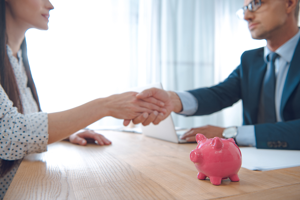 Bank officer with businessperson shaking hands